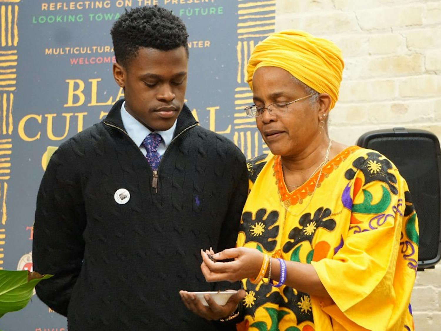 UW-Madison’s Black Student Union President Marquise Mays and Program Development and Assessment Specialist in the Division of Student Life Hazel Symonette spread tobacco around the new Black Cultural Center space during a dedication and libation ceremony.