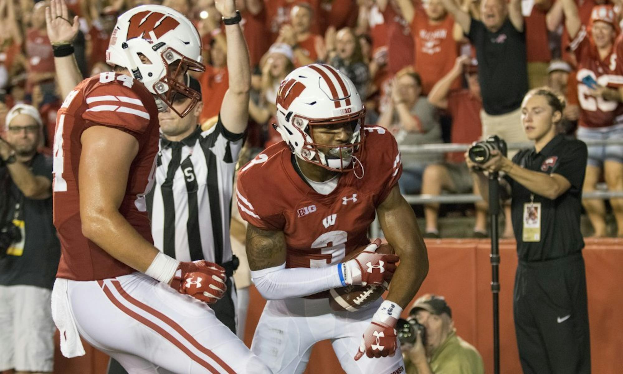 Tight end Jake Ferguson (left) celebrates with receiver Kendric Pryor after Pryor's touchdown grab put the Badgers up 24-0 at the close of the second quarter.