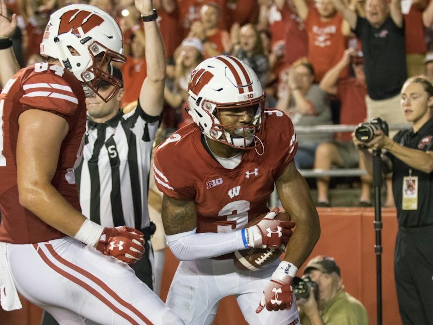 Tight end Jake Ferguson (left) celebrates with receiver Kendric Pryor after Pryor's touchdown grab put the Badgers up 24-0 at the close of the second quarter.