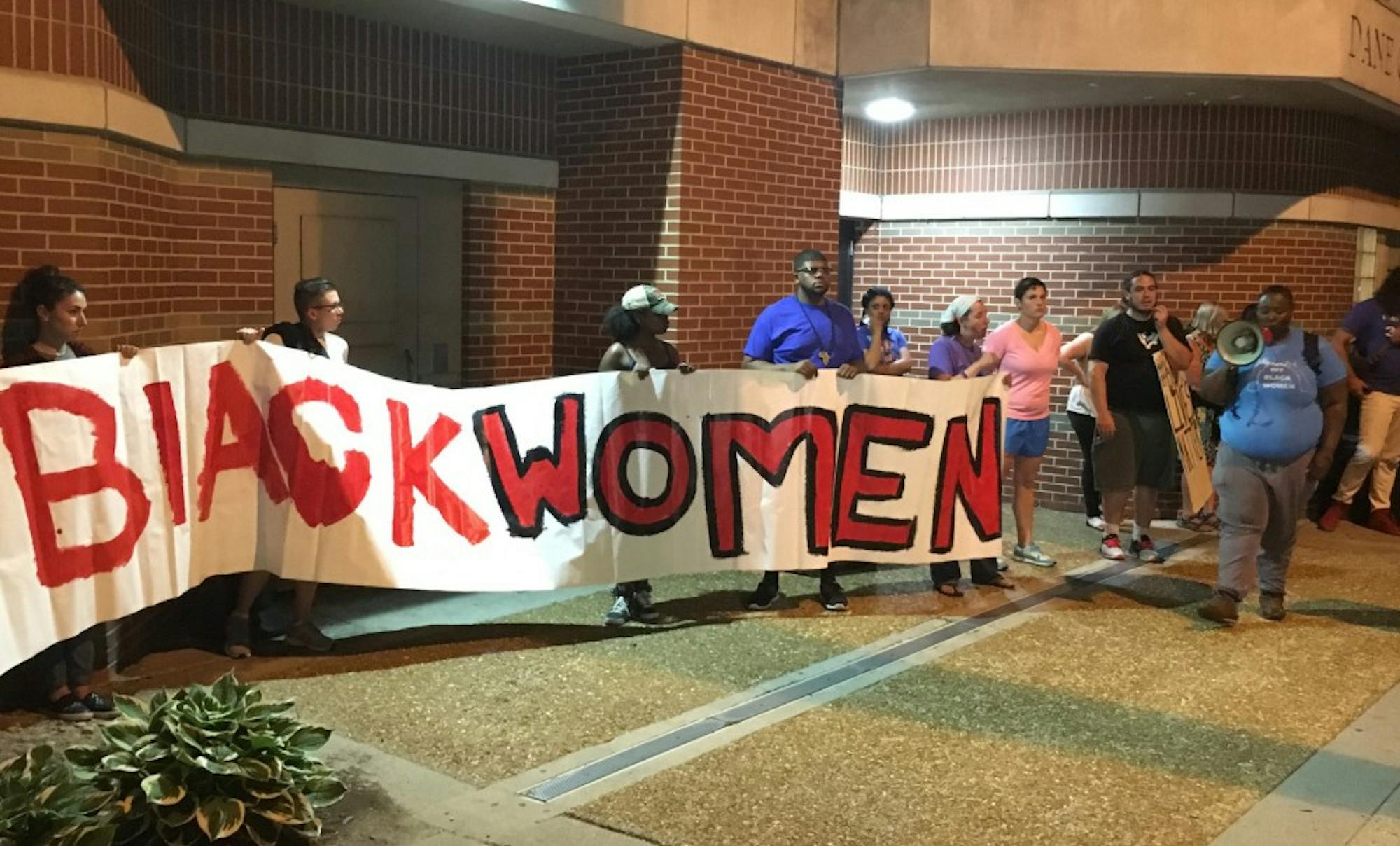 Roughly 40 demonstrators gathered at the Dane County Public Safety Building, holding a sign that reads “Hands off Black Women” to protest MPD’s arrest of Genele Laird, an 18-year-old black woman.