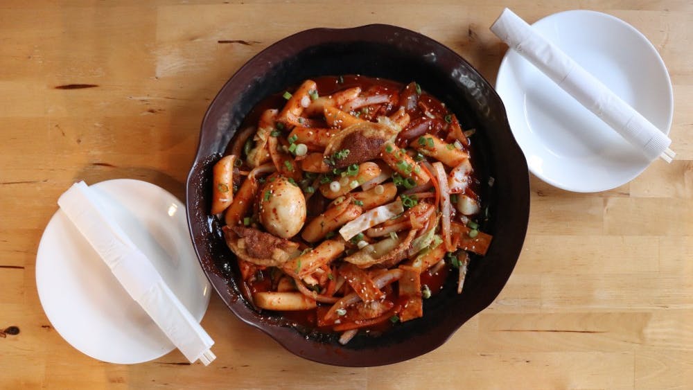 Tteokbokki is a Korean dish that has stir-fried rice cakes, typically served spicy when mixed with gochujang, a type of Korean chili paste.&nbsp;