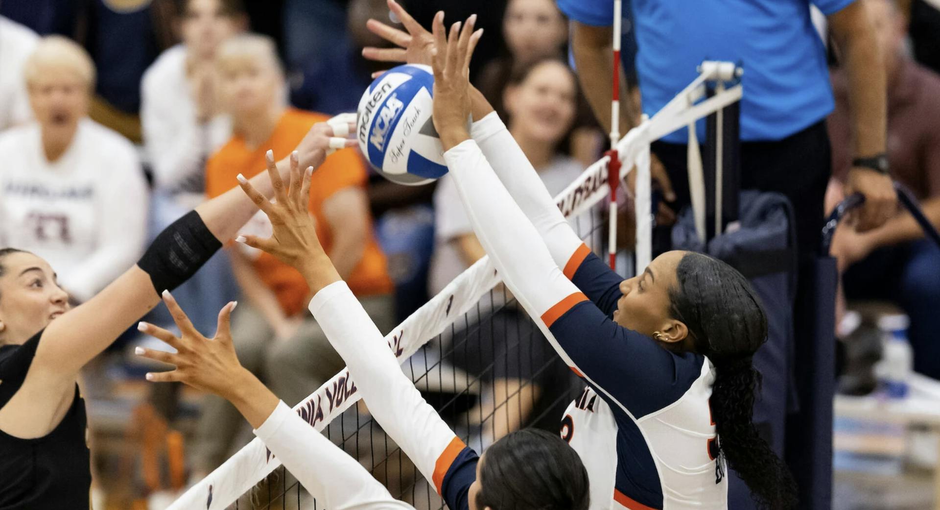 Two Virginia blockers rise up during a match over the weekend against Appalachian State.