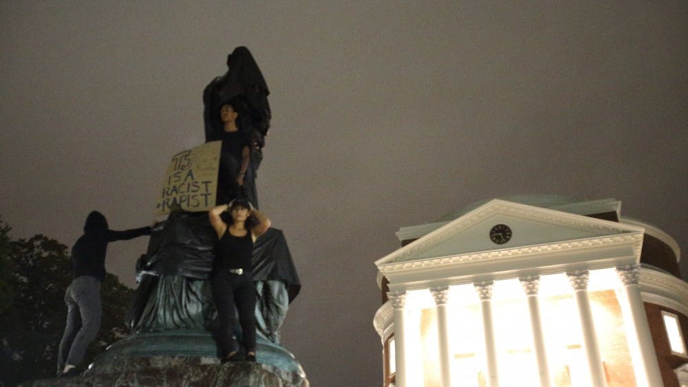 A month after white supremacists gathered for the Unite the Right rally, a group of students, faculty and Charlottesville community members covered the Thomas Jefferson statue in front of the Rotunda with a tarp and placed a sign on top reading, “TJ is a racist and rapist.”