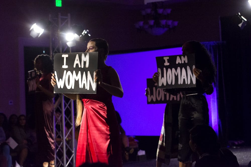 Models held signs reading "I Am Woman" during all-female collection on display at this year's Fashion for a Cause show.