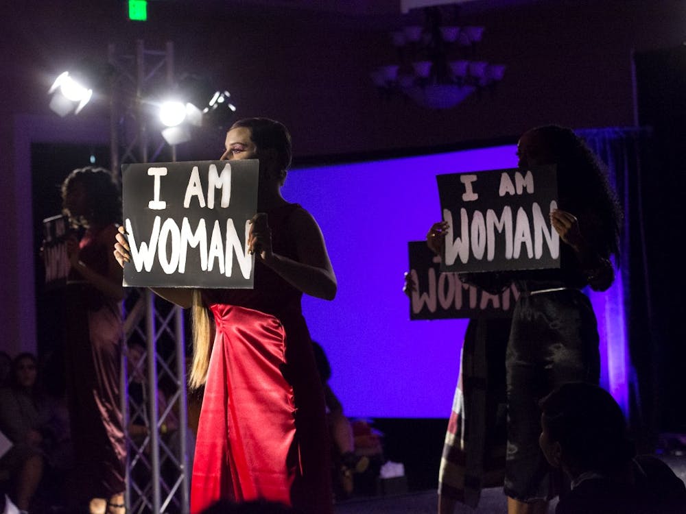 Models held signs reading "I Am Woman" during all-female collection on display at this year's Fashion for a Cause show.