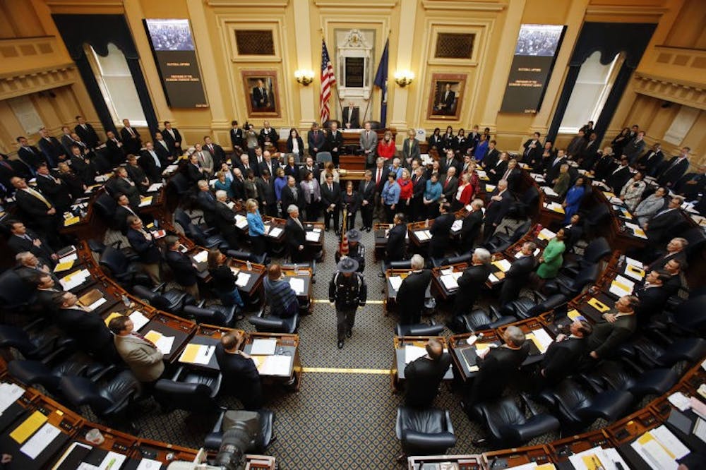 Members of the Virginia Capitol Police retire the colors after the Richmond Symphony Chorus (encircling the Speaker's podium) sang the National Anthem to open the 2013 session of the Virginia House of Delegates at the State Capitol in Richmond, VA Wednesday, Jan. 9, 2013.