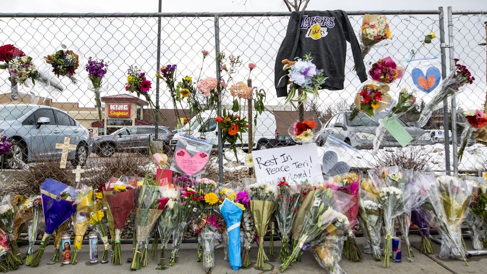 Hundreds of people visited the site of a mass shooting at a Boulder, Colo. King Soopers to leave flowers, cards and candles on March 23, 2021.