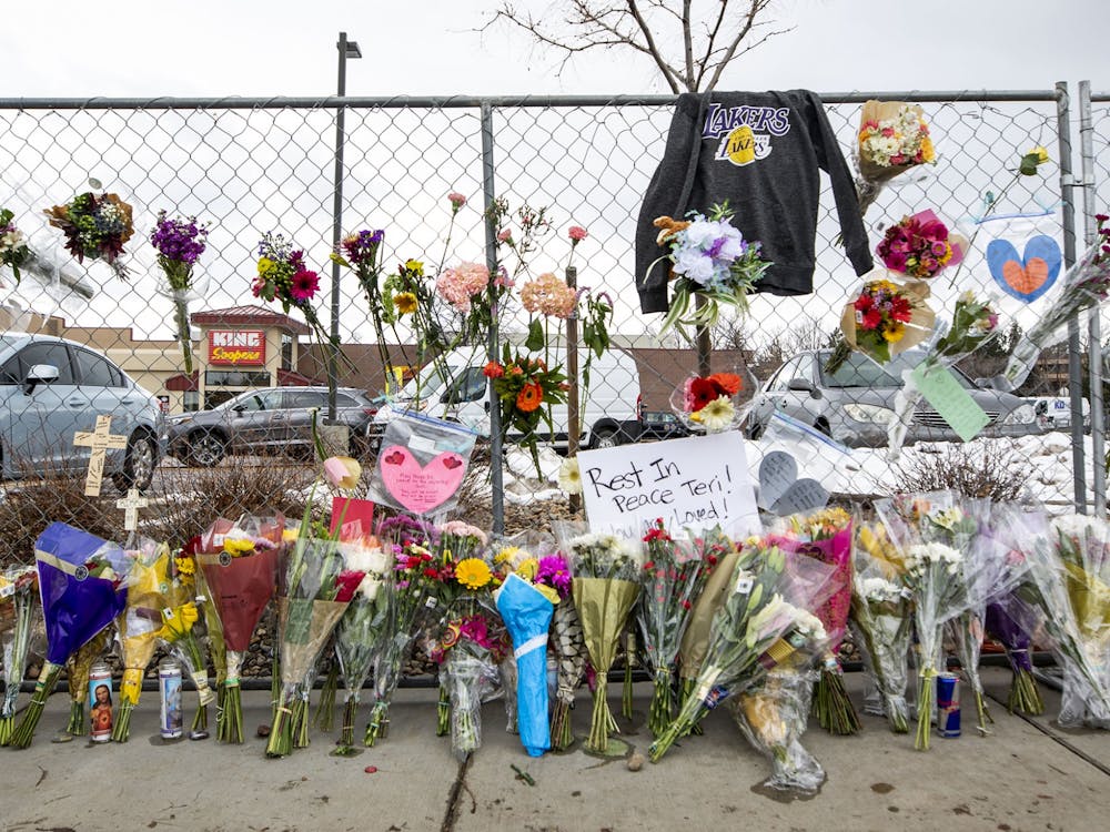 Hundreds of people visited the site of a mass shooting at a Boulder, Colo. King Soopers to leave flowers, cards and candles on March 23, 2021.