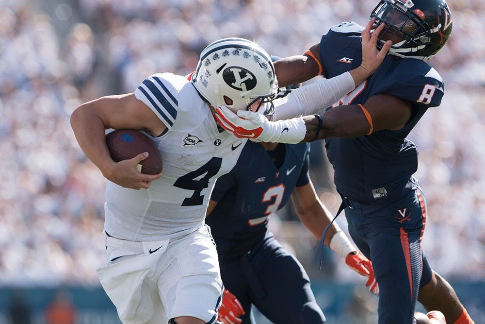 Junior quarterback Taysom Hill threw two touchdowns and ran for another as he led No. 21 Brigham Young past Virginia in Provo, Utah Saturday, 41-33.