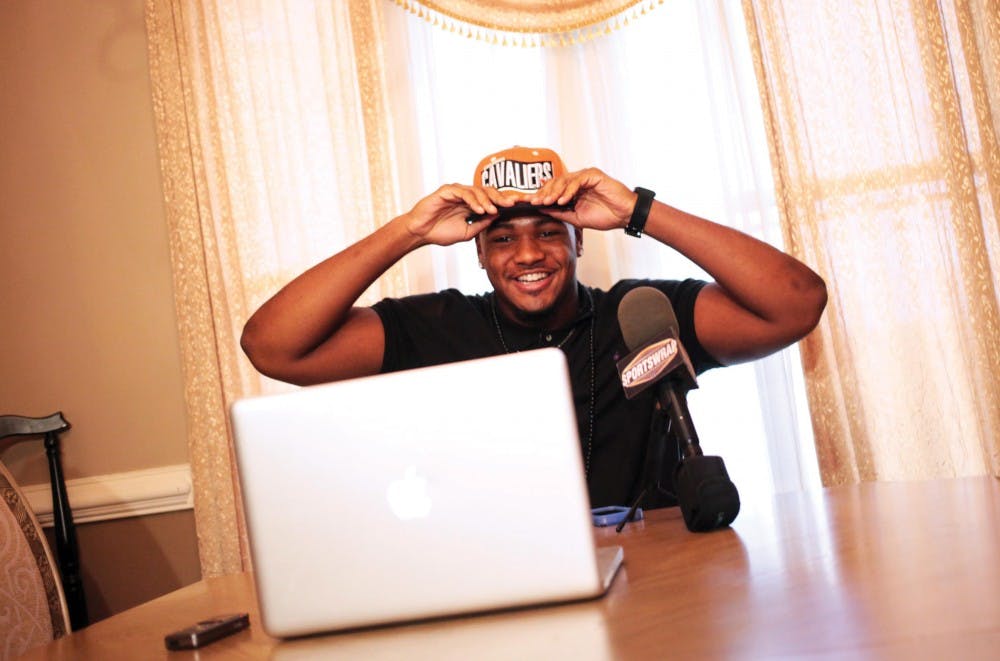 Oscar Smith High School defensive tackle Andrew Brown of Chesapeake, Va. announces on Saturday, June 29, 2013 in his home that he will be playing football at the University of Virginia. (Dorothy Edwards | The Virginian-Pilot)