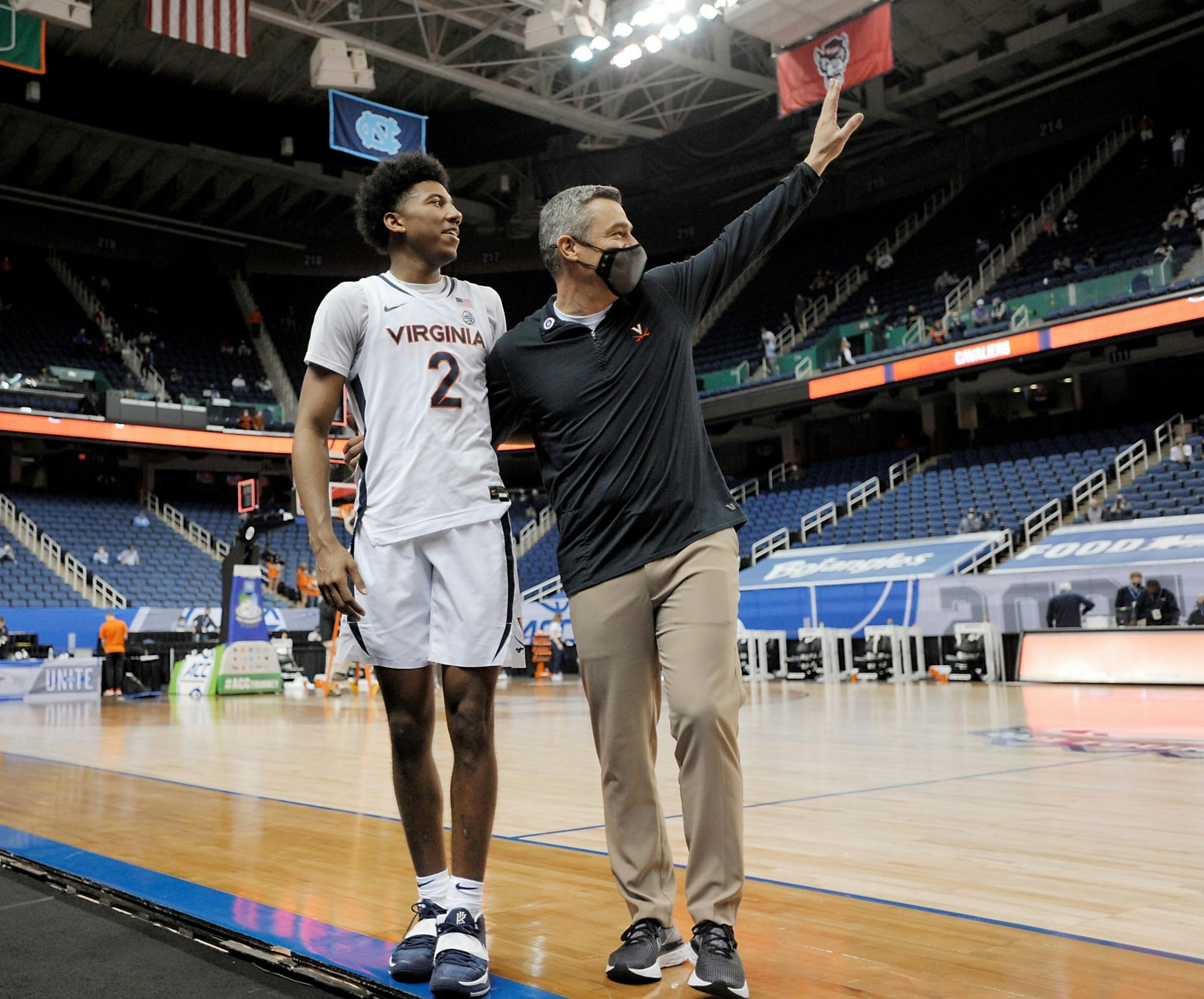 Virginia Coach Tony Bennett and freshman guard Reece Beekman celebrate after beating Syracuse Thursday in the ACC Tournament quarterfinals