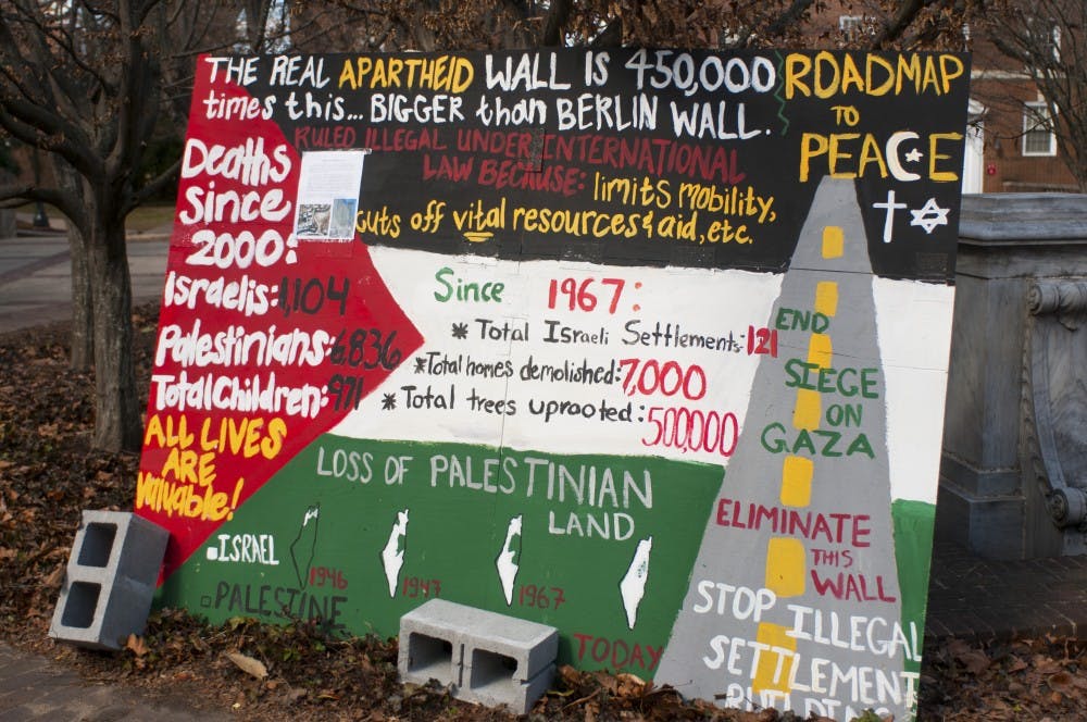 	<p>The mock wall outside of Monroe Hall features maps of Palestinian and Israeli land as well as death tolls of both Israelis and Palestinians.</p>