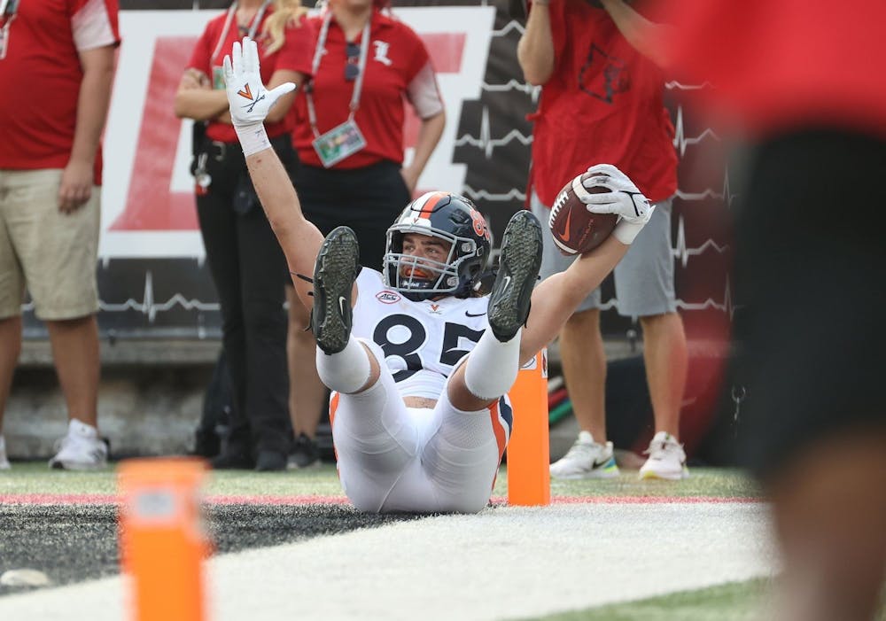 <p>Virginia junior tight end Grant Misch celebrates after scoring the game-winning touchdown with less than 30 seconds remaining against Louisville Saturday afternoon.</p>