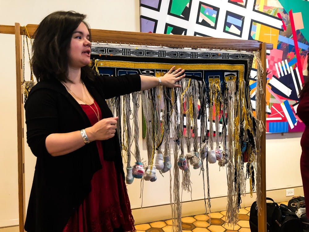 Artist Lily Hope demonstrates the craft of Chilkat weaving at the Fralin.