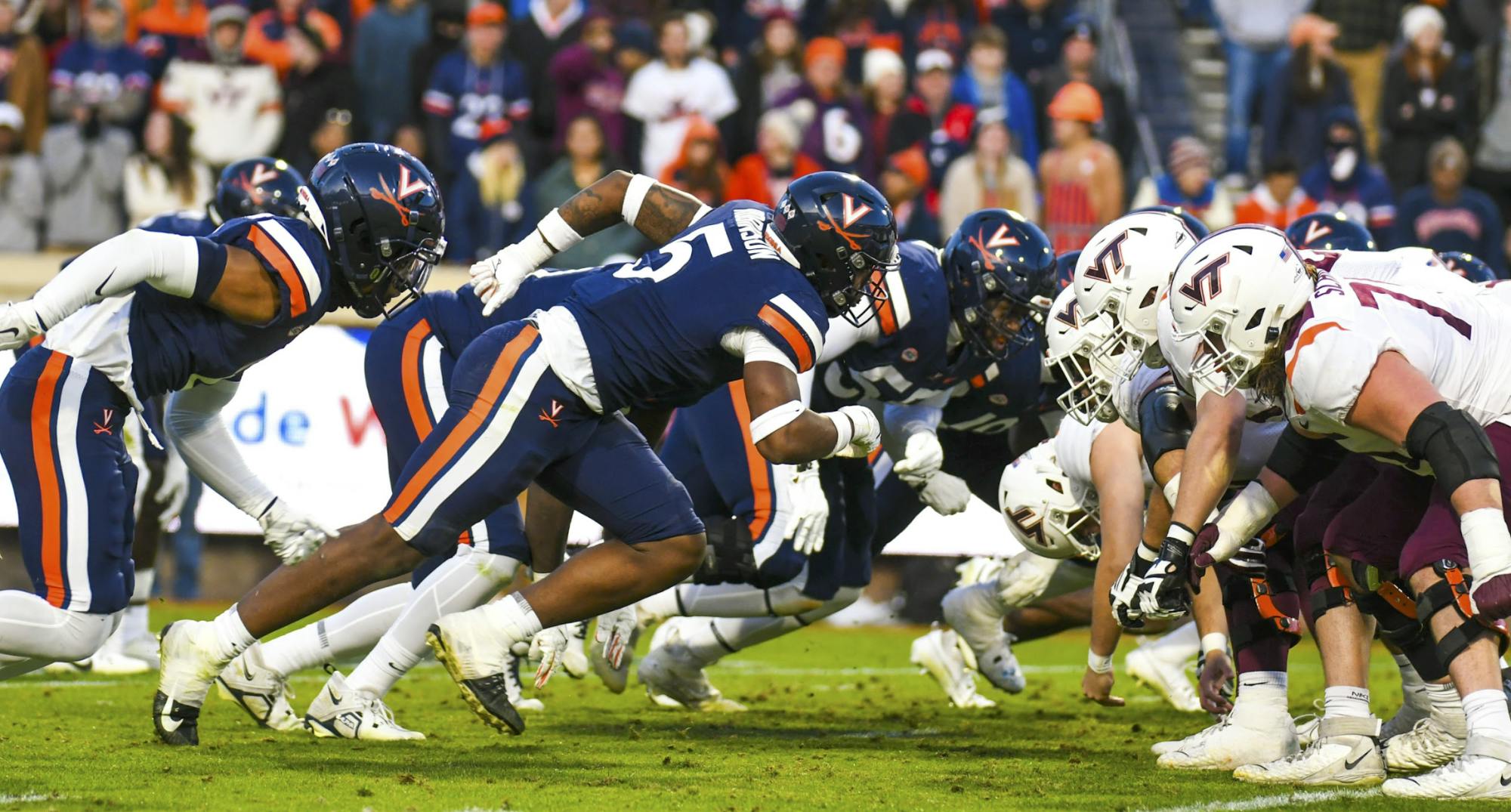 The Cavaliers and Hokies collide at the line of scrimmage Nov. 25, 2023.