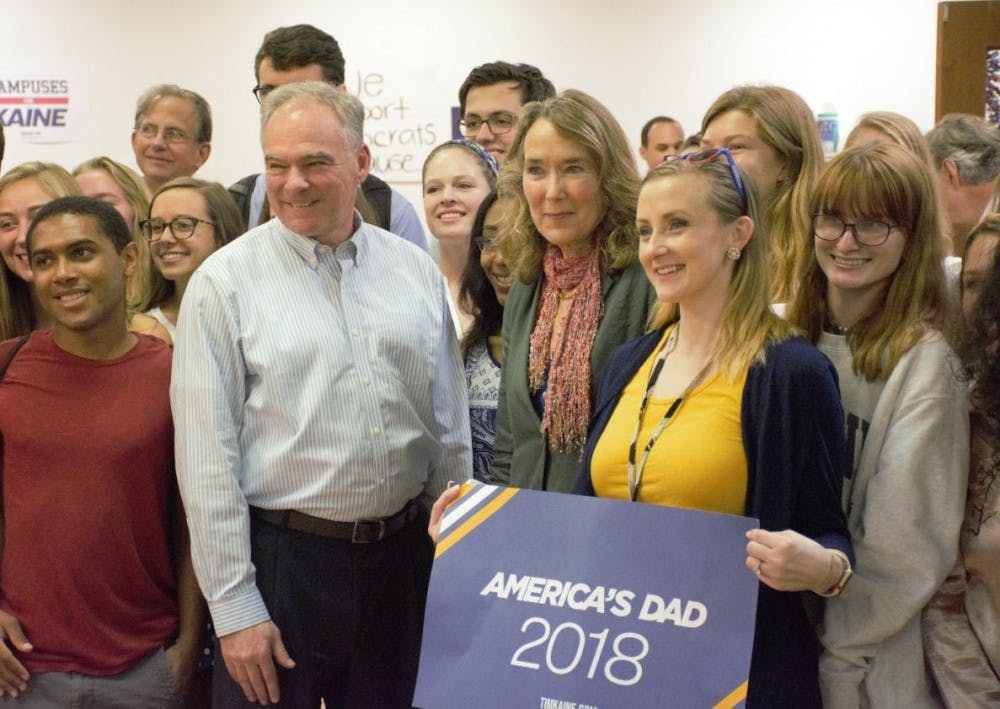 <p>Sen. Tim Kaine and Leslie Cockburn pose for a picture with members of the University Democrats.&nbsp;</p>