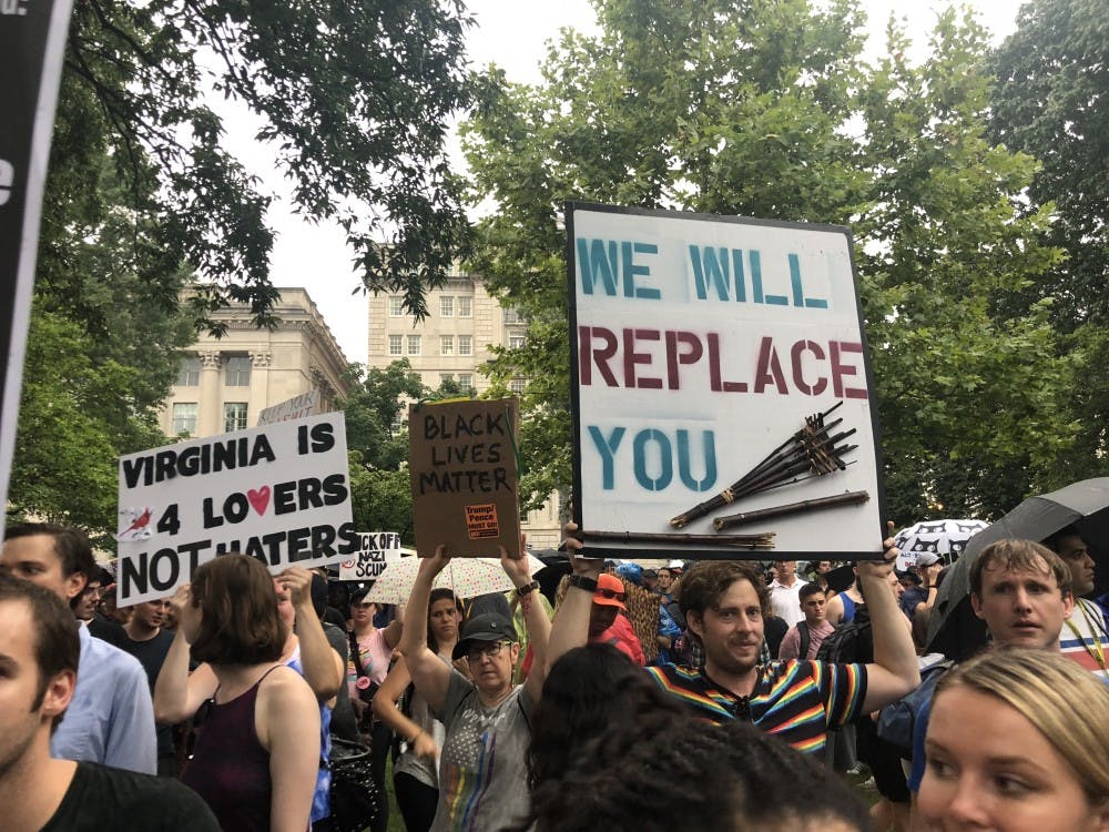 <p>Several signs held by counterprotestors referenced last year's events in Charlottesville.</p>
