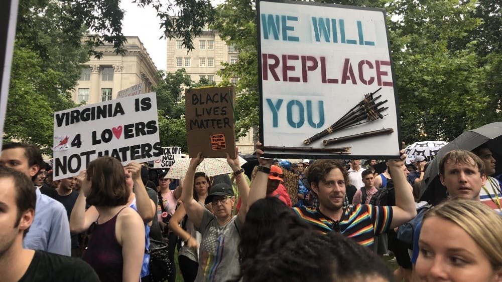 Several signs held by counterprotestors referenced last year's events in Charlottesville.