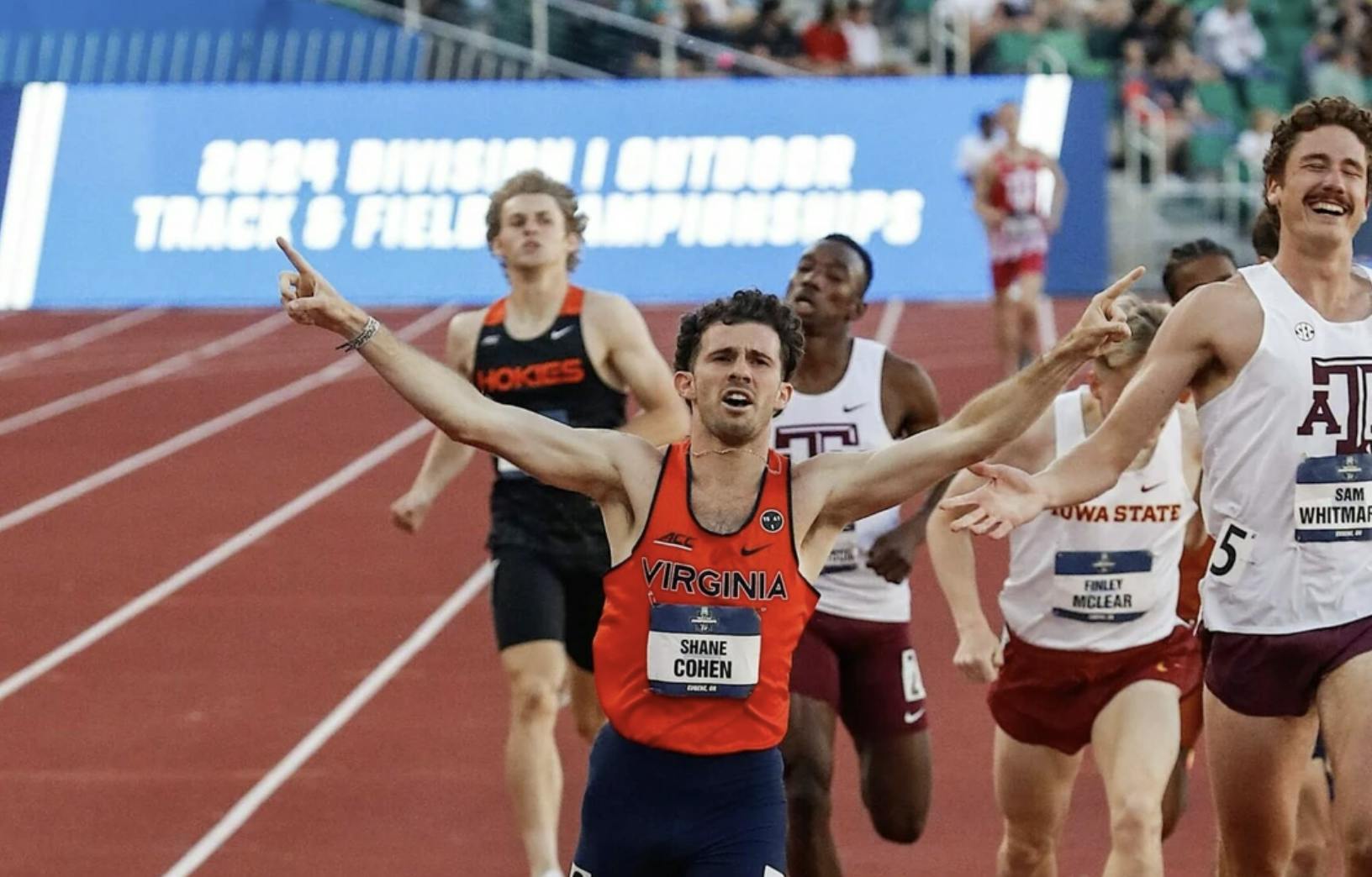 Cohen raises his arms as he crosses the finish line as a national champion.