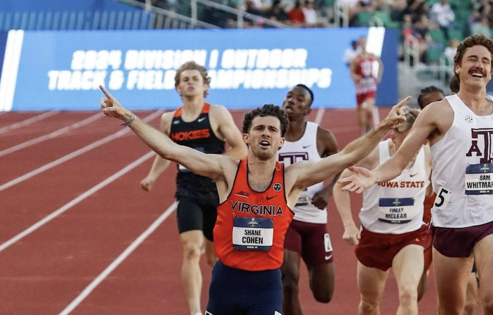 <p>Cohen raises his arms as he crosses the finish line as a national champion.</p>