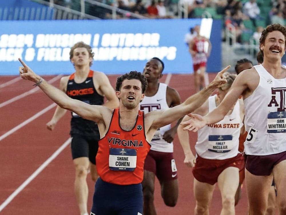 Cohen raises his arms as he crosses the finish line as a national champion.