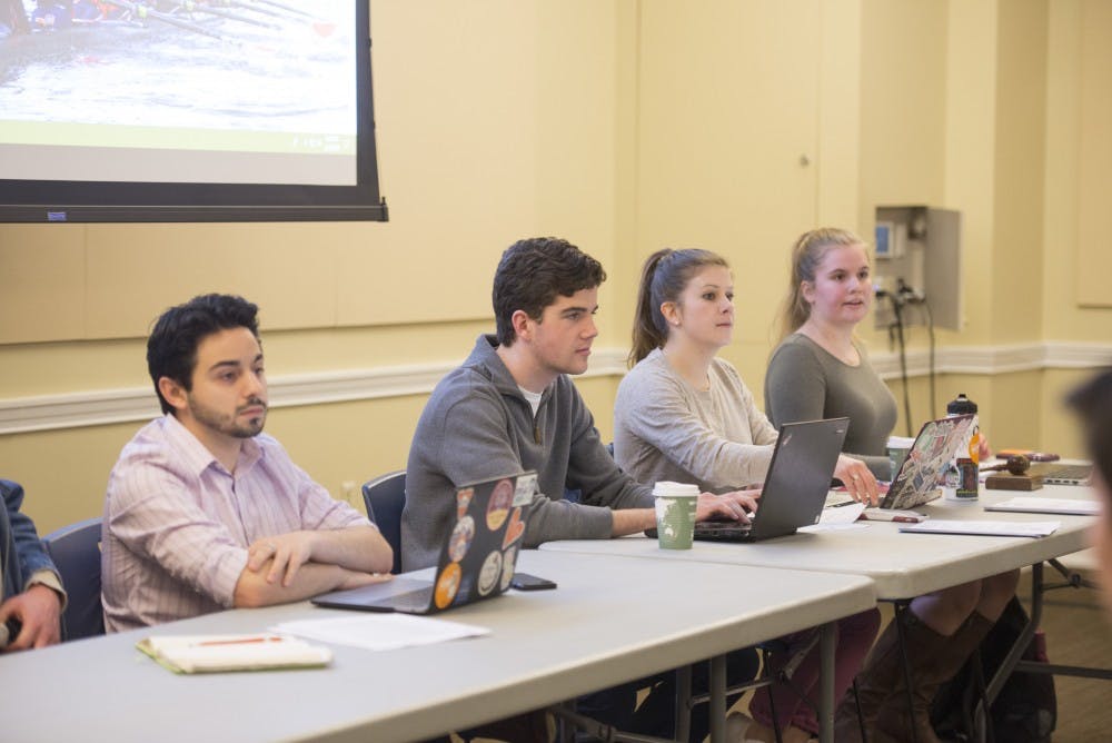 <p>Student Council President-Elect Alex Cintron (left) at Tuesday's meeting.&nbsp;</p>