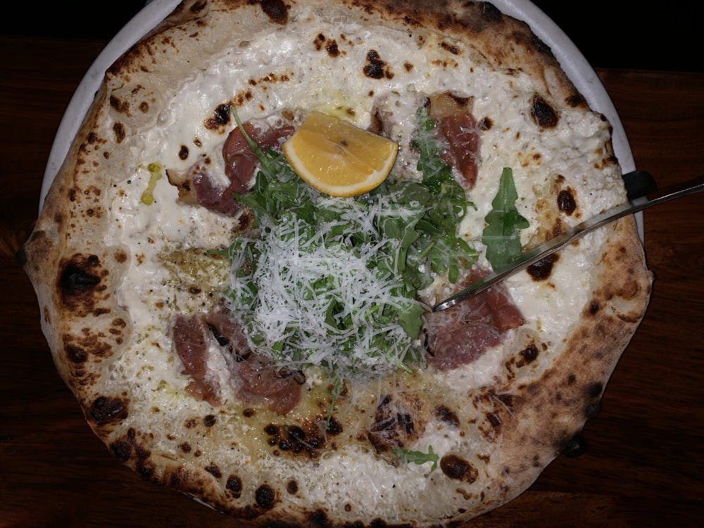 <p>The prosciutto pizza at Lampo is topped with prosciutto, arugula, grana padano cheese and lemon. &nbsp;</p>