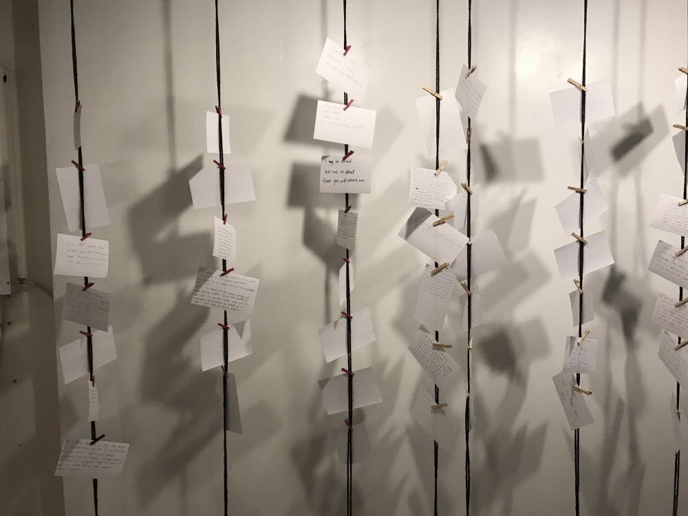 <p>Dozens of Destinee Wright's Solidarity Cards hang at The Bridge Progressive Arts Initiative.</p>