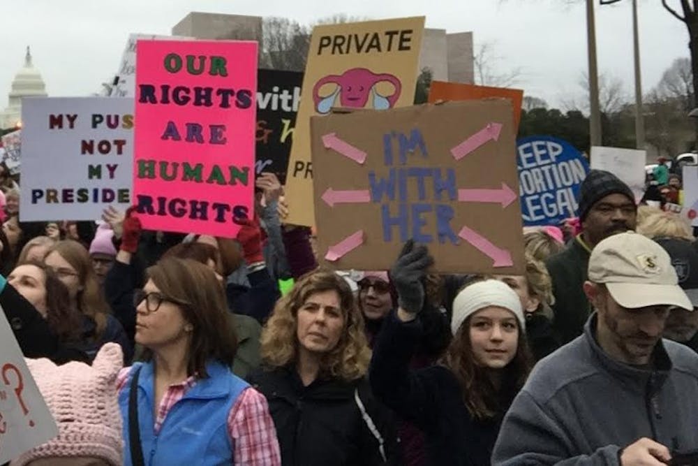 <p>Protesters at the Women's March in DC last week display signs.</p>