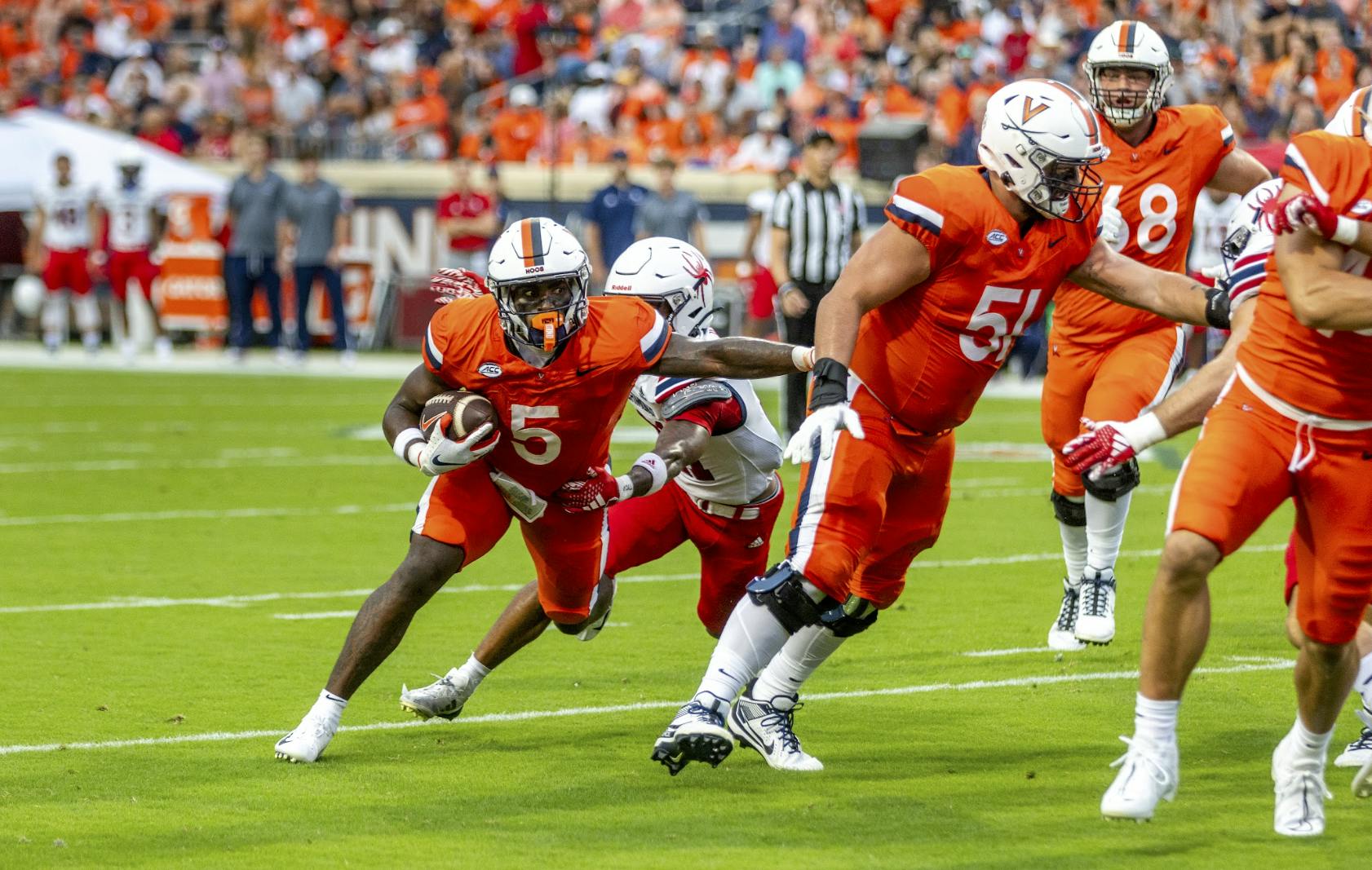 Graduate running back Kobe Pace fights for yardage, aided by a solid performance from the Cavaliers offensive line.