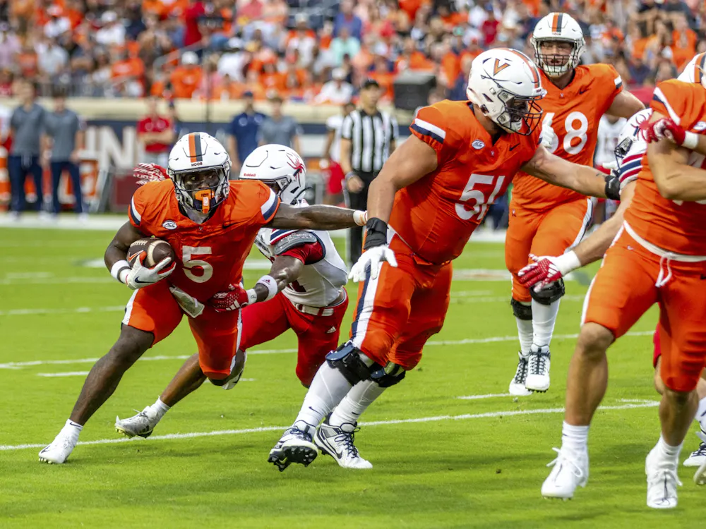 Graduate running back Kobe Pace fights for yardage, aided by a solid performance from the Cavaliers offensive line.
