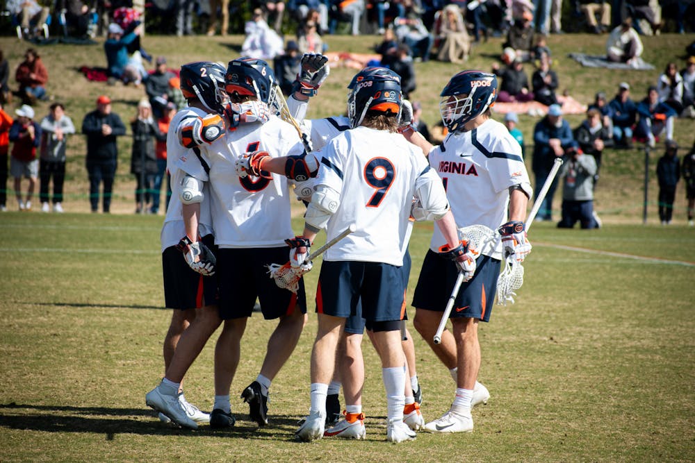 <p>A group of Cavaliers celebrates after a goal.</p>