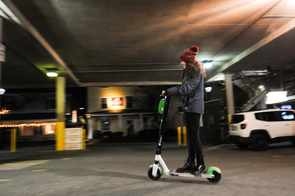 <p>College student Emma Klein rides a lime scooter.</p>