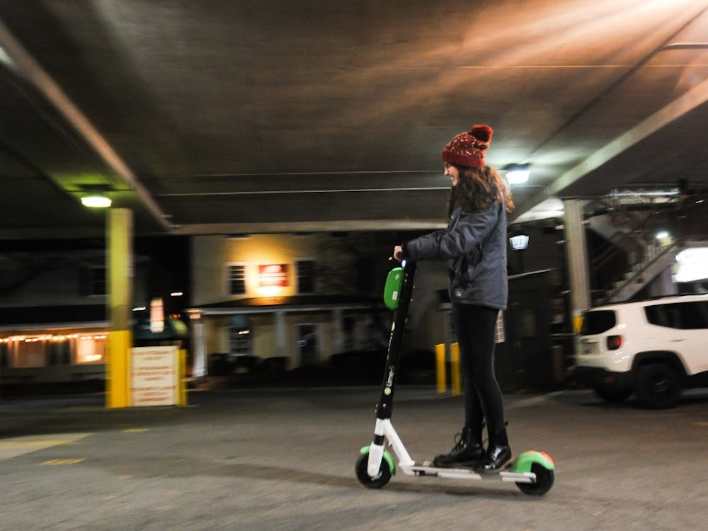 College student Emma Klein rides a lime scooter.