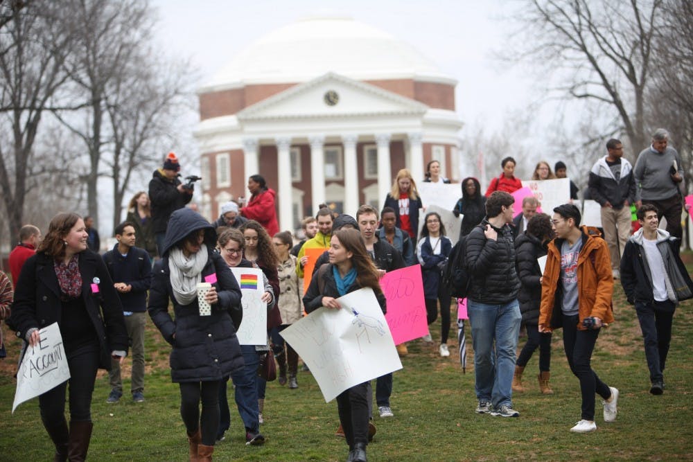 Students with signs&nbsp;protesting on the Lawn Friday.