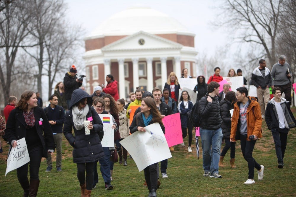 <p>Students with signs&nbsp;protesting on the Lawn Friday.</p>