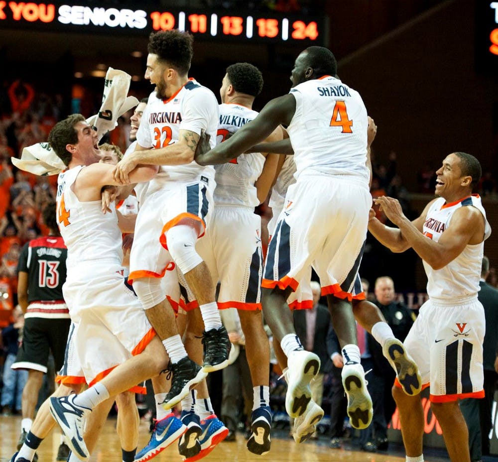 The Virginia basketball team celebrates their 68-46 win over No. 11 Louisville. The Cavaliers finished with a perfect 15-0 record at home. Virginia last went undefeated at home in the 1981-82 season.