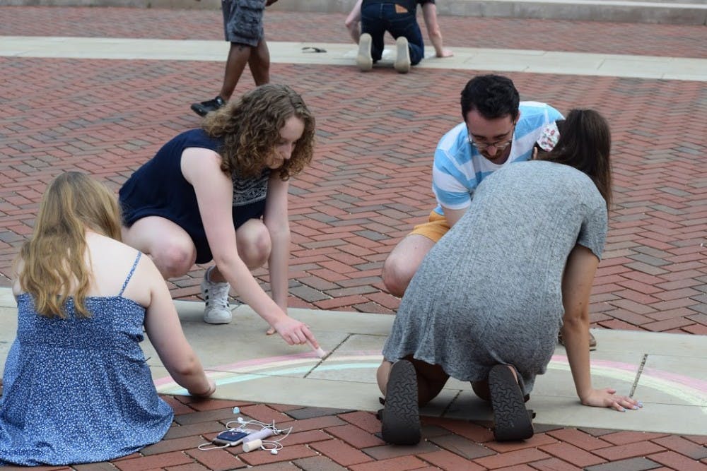 The event started with attendees chalking the sidewalk with messages of support for the victims of the shooting.