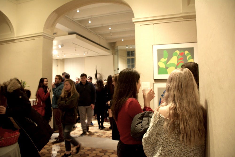 Three girls – one dressed, of course, in maroon — stood against the wall leading to the upstairs exhibits.
