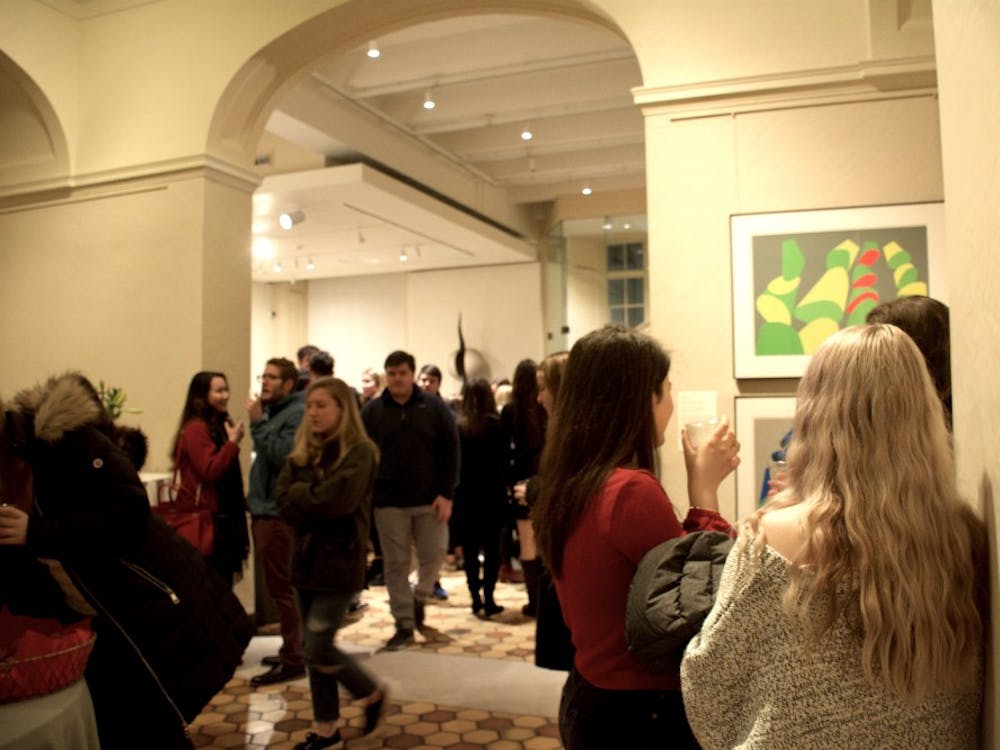 Three girls – one dressed, of course, in maroon — stood against the wall leading to the upstairs exhibits.