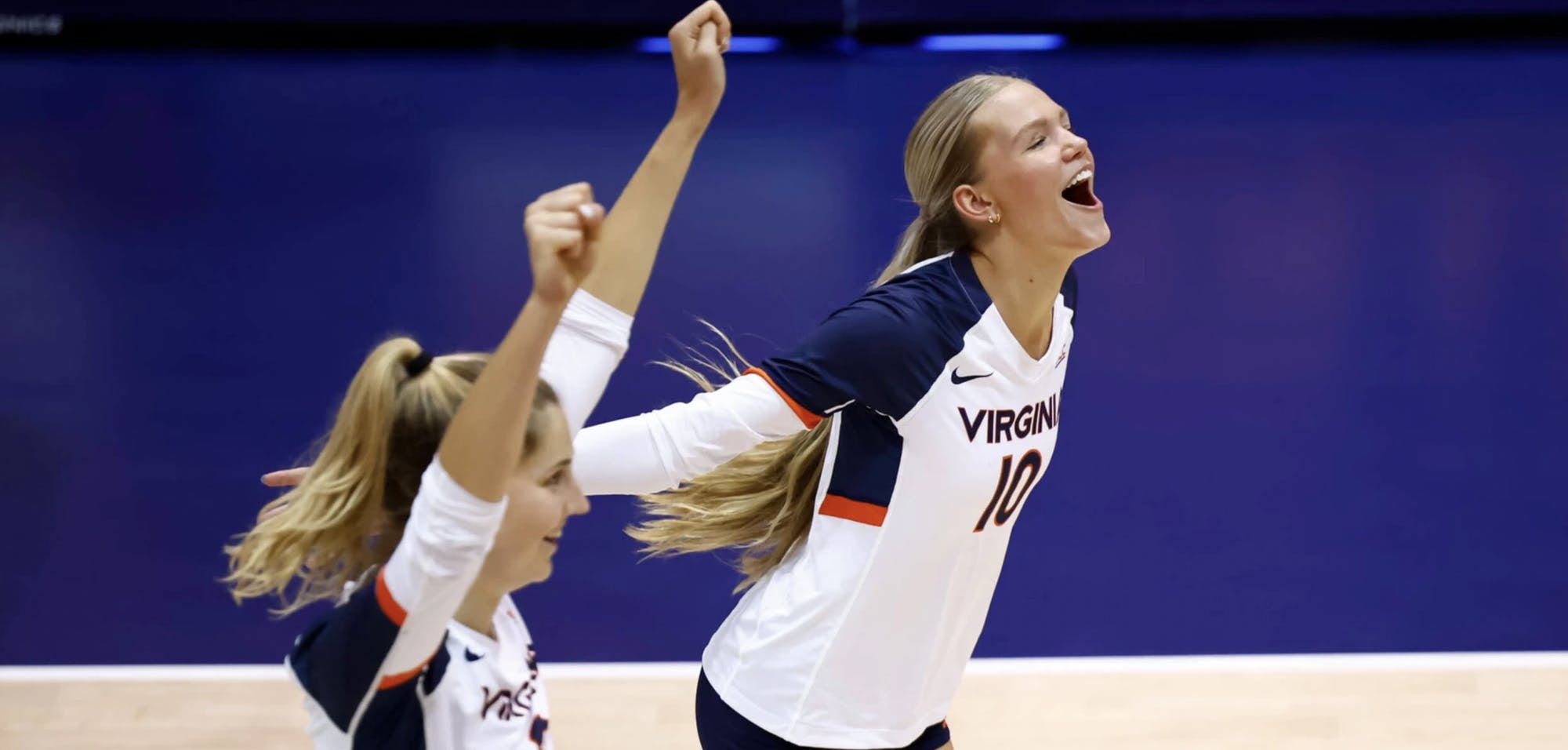 Freshman striker Zoey Dood and senior middle blocker Abby Tadder celebrate after scoring another Virginia point.