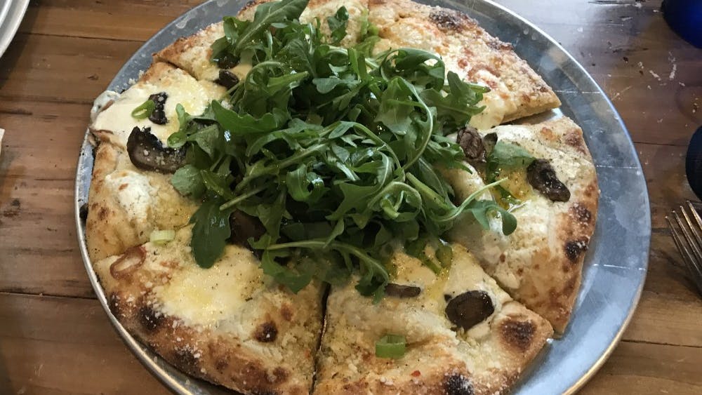 I ordered the Funghitown pizza, which was a vegetarian pizza topped with mushrooms, caramelized onions, white sauce, mozzarella and arugula.