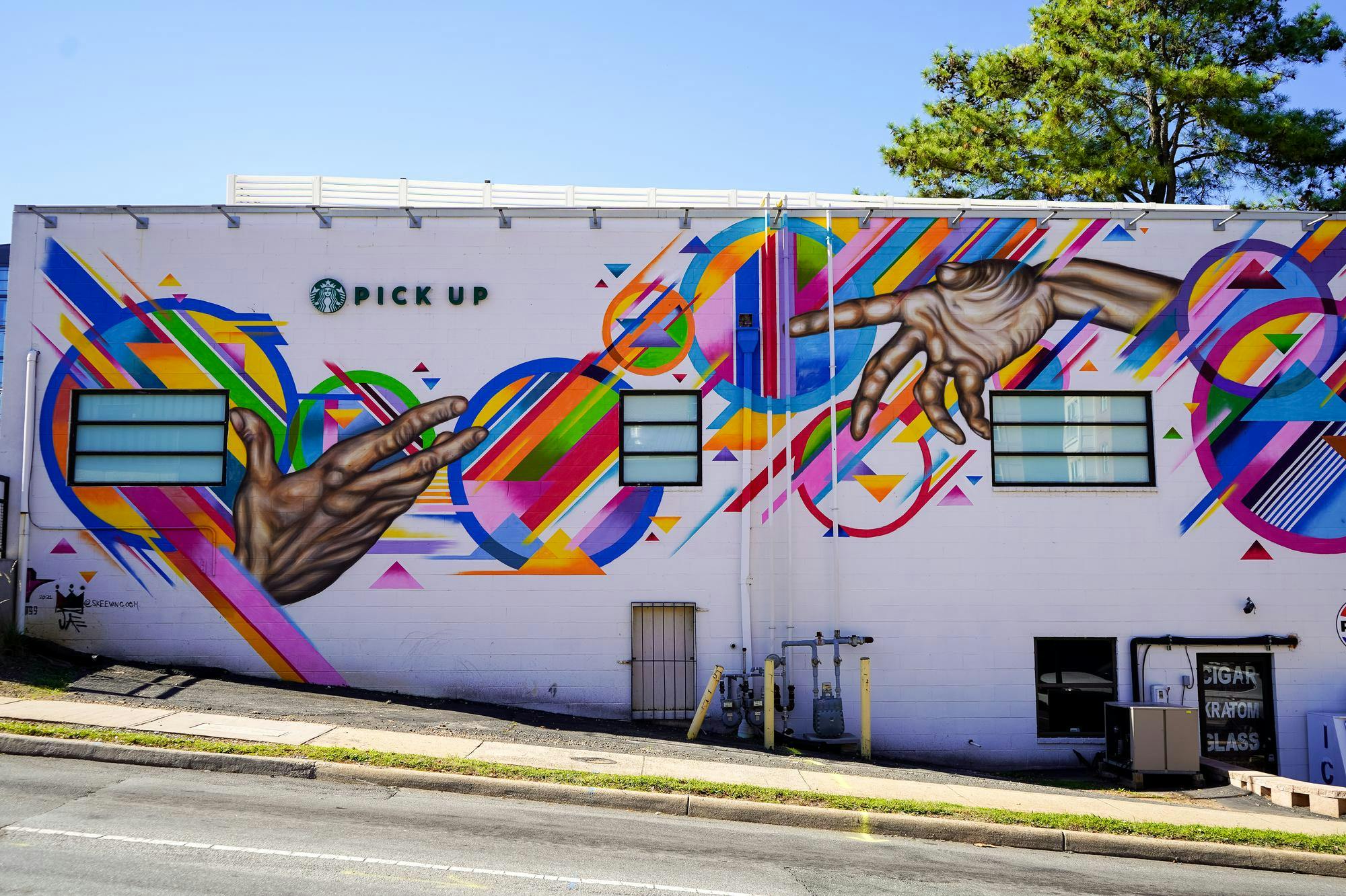 Johnson’s first major mural can be found on the exterior of the Starbucks on West Main Street, where bright, kinetic figures bring optimism to what would otherwise be an unremarkable facade
