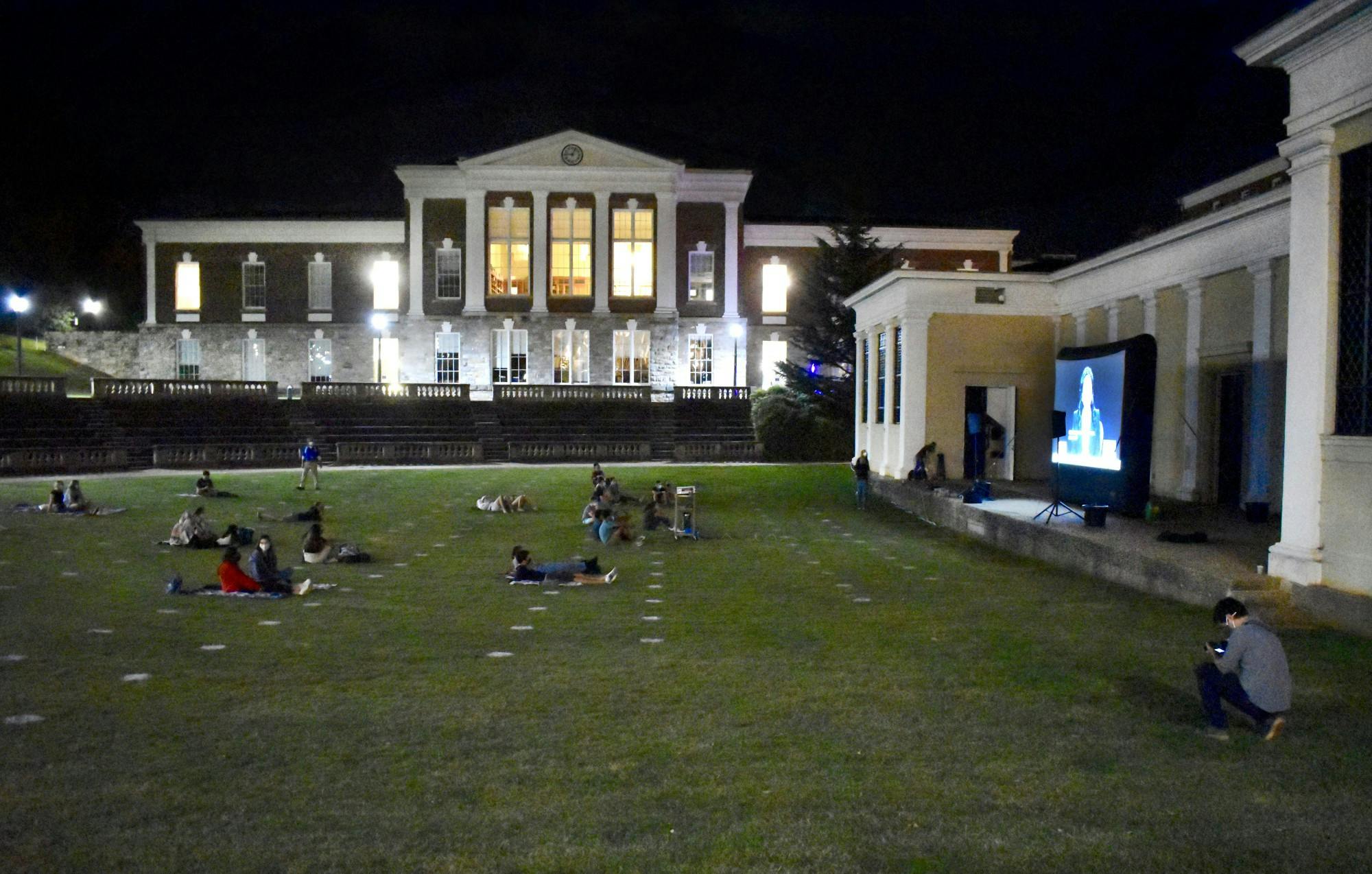 About 50 students sat in the grass and on the stairs of the amphitheater to watch, and the debate was projected onto a large screen in front of Bryan Hall.