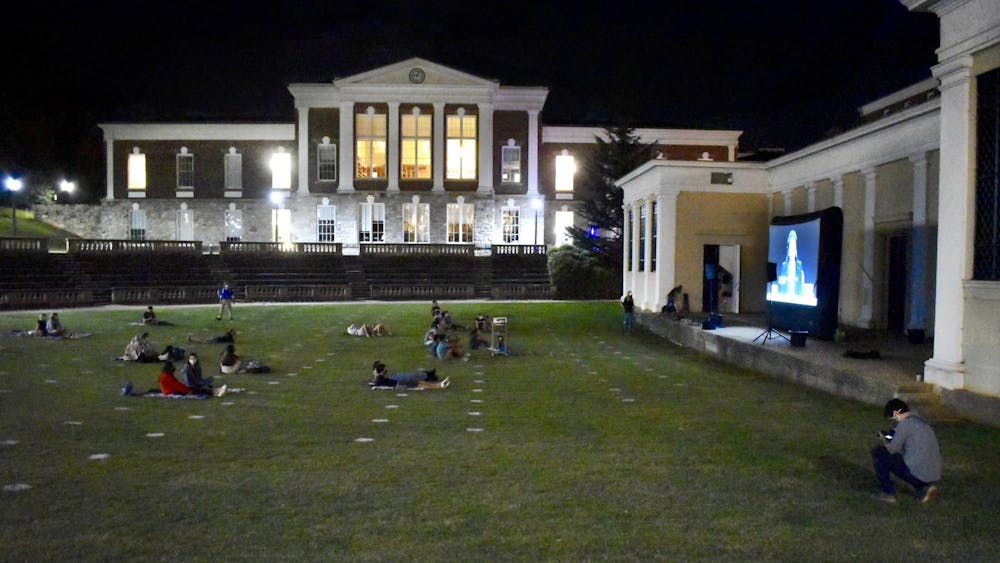 About 50 students sat in the grass and on the stairs of the amphitheater to watch, and the debate was projected onto a large screen in front of Bryan Hall.