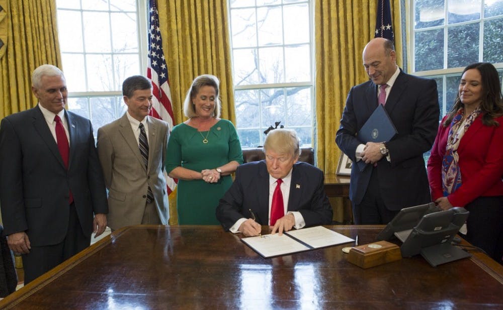 <p>President Donald Trump signing an executive order</p>