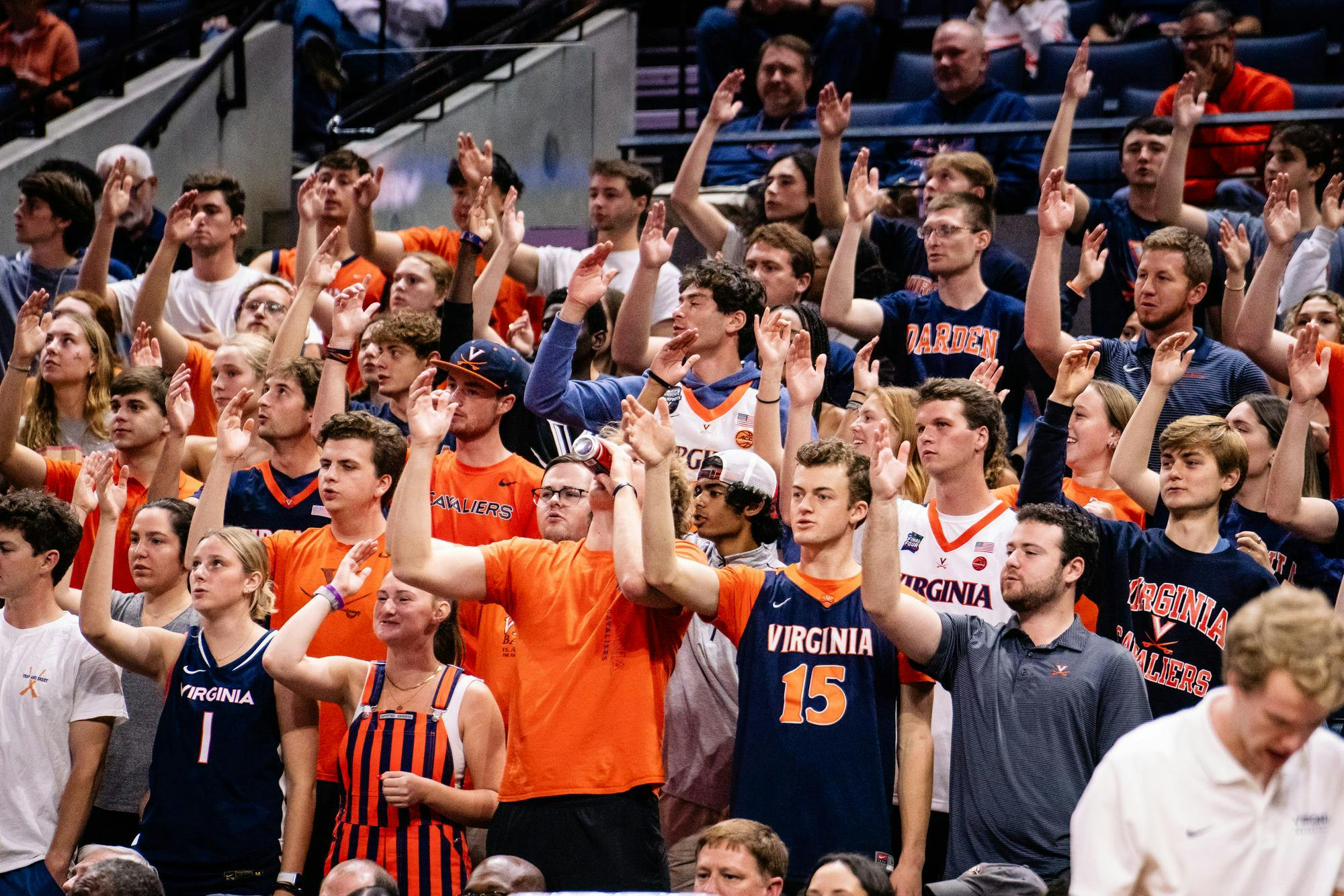 Students in the front row at a men's basketball game, reaping the rewards of Sabre Points mastery.