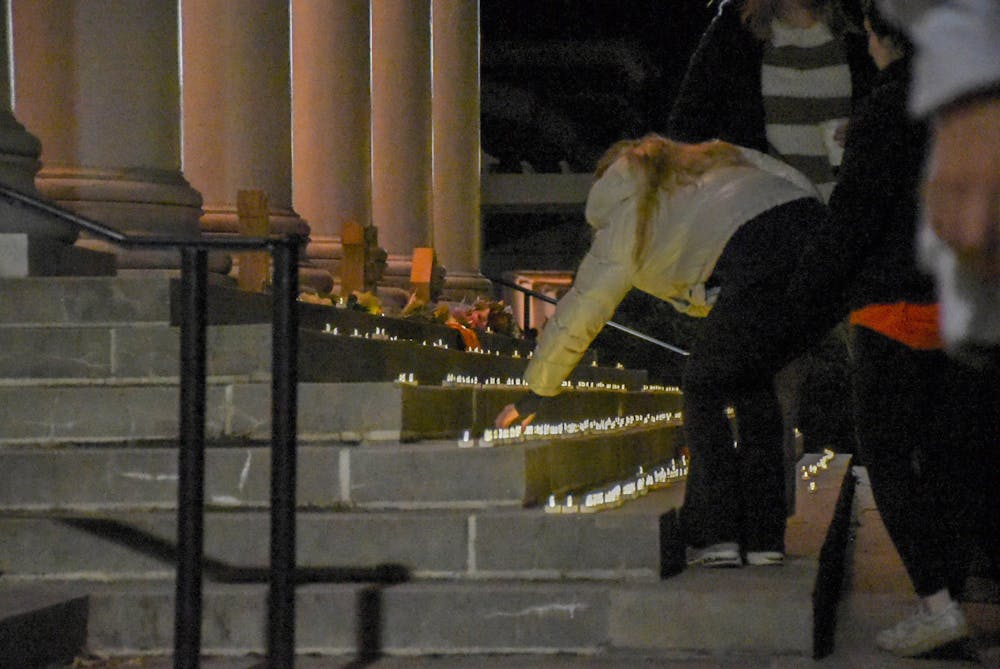 Attendees took candles from tables on South Lawn and walked them over to place them on the steps of Old Cabell Hall beginning at 7 p.m..
