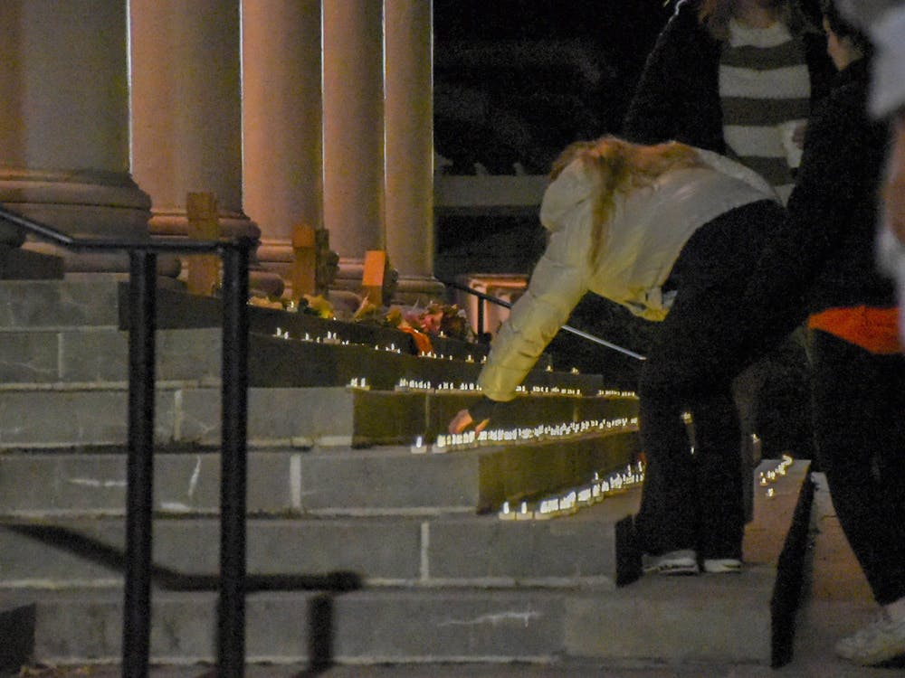 Attendees took candles from tables on South Lawn and walked them over to place them on the steps of Old Cabell Hall beginning at 7 p.m..
