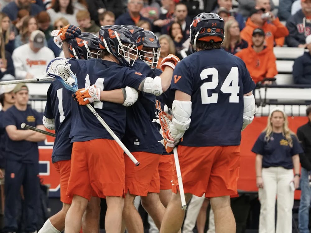 A bundle of Cavaliers celebrate after scoring a goal.